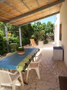 a patio with a blue table and chairs on a patio at Casa Vacanza Mare in Castellammare del Golfo