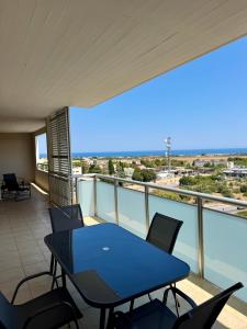 a blue table and chairs on a balcony at Best Stay-Airport Bari Palese in Macchie