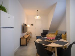 a living room with a table and chairs at Apartamentos Marmolejos in Gáldar