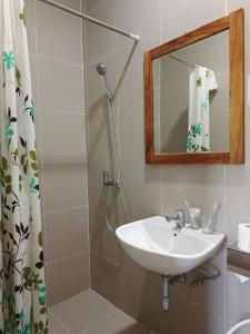 a bathroom with a sink and a mirror at Spring Hill Hotel Ruteng in Ruteng +40 photos