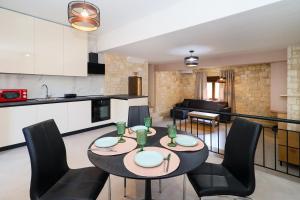 a kitchen and living room with a table and chairs at Villa Mykeli in Kriopigi