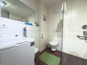 a bathroom with a sink and a toilet at Alm Loge in Oberstaufen +6 photos