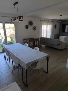 a living room with a table and chairs at Villa Eden in Latour-Bas-Elne