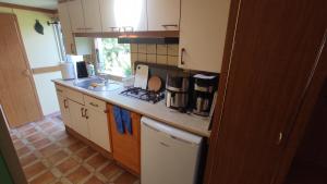 a kitchen with a sink and a counter top at Domki u Ewy in Wrzosowo +32 photos