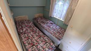 two beds sitting in a corner of a room at Domki u Ewy in Wrzosowo