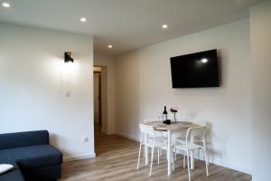 a living room with a table and chairs and a couch at Lipowa Apartamenty in Szczawno-Zdrój