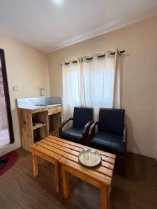 a living room with a bench and a table and a chair at Cityview Guest House in Kathmandu