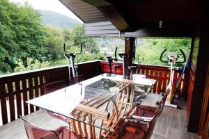 a table and chairs on the balcony of a train at Holiday house "Villa Dalia" in Bihać