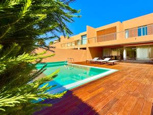 an image of a house with a swimming pool at Salgados Premium Beach Villa 4 Suites in Guia