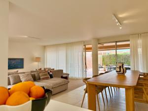 a living room with a couch and a table at Salgados Premium Beach Villa 4 Suites in Guia