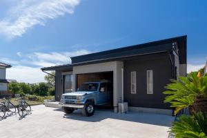 a truck parked in the garage of a house at Garage Base TATEYAMA in Tateyama +76 photos