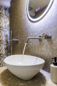 a white bowl sink sitting on a counter in a bathroom at Maritina Skopelos Maisonette in Skopelos Town +17 photos