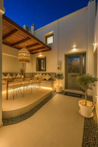 een patio met een tafel en stoelen en een potplant bij Heliareti Traditional House in Koskinou