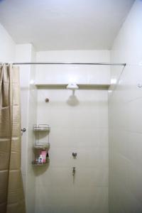 a bathroom with a shower with a glass door at Large Studio In Heart of Westlands in Nairobi