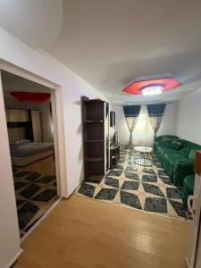 a living room with a green couch in a room at Hostel la Bubu in Costinesti