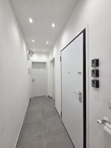 a hallway with a door and a mirror at Mammarusina in Brindisi