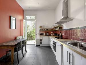 a kitchen with a wooden table and a counter top at Villa Familiale près du Moulleau et Plage des Arbousiers avec Grand Jardin et Terrasse - FR-1-433-18 in Arcachon
