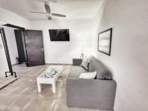 a living room with a couch and a table at Volax280 Syros Amazing View in Episkopíon