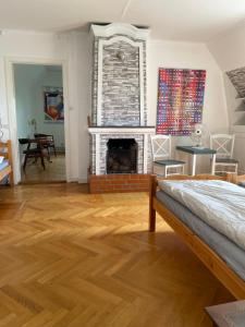 a living room with a fireplace and a bed at Rosa Villan Högsby 2 in Högsby