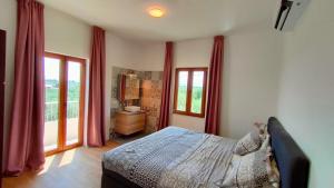 a bedroom with a bed with red drapes at Guesthouse Las Hamacas Abruzzo in Pianella