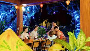 a group of people sitting at a table in a restaurant at Ninh Binh Kong's Homestay in Nguyên Ngoại