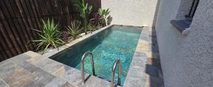 a small swimming pool next to a building at UBUD - Piscine Chauff - Recharge Auto - 10min Canet Barcarès in Sainte-Marie-la-Mer