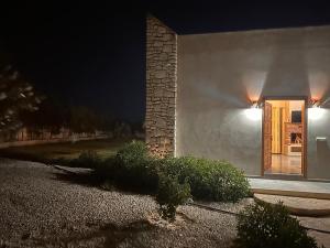 a white building with a door at night at Dar essafae in Essaouira