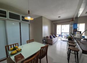 a kitchen and living room with a table and chairs at COP 30 Apartamento Luxo - 3 Quartos, Piscina, Academia, Area de Lazer in Belém +13 photos