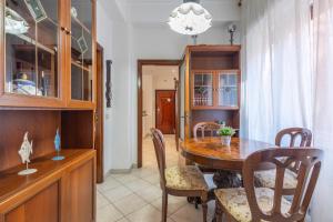 a dining room with a wooden table and chairs at Vintage al passetto - Ancona Centro in Ancona