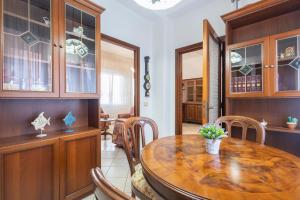 a dining room with a wooden table and chairs at Vintage al passetto - Ancona Centro in Ancona +22 photos