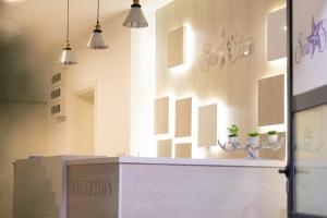 a kitchen with a counter with two potted plants on the wall at Sea Star Apartments in Ulcinj +83 photos
