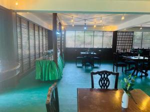 a dining room with a table and chairs and blue floors at Lake Wind Resort & Restaurant in Polgahawelana