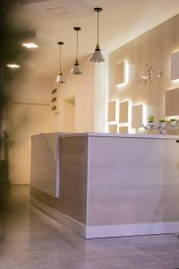 a reception desk in a room with pendant lights at Sea Star Apartments in Ulcinj