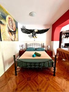 a bird flying over a bed in a bedroom at Casa BB&Djassi - Studio in Ponta do Sol
