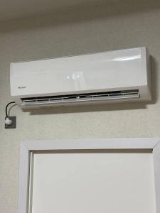 a white air conditioner is hanging above a door at Cosiness Hostel in Osh