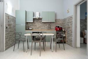a kitchen with a table and chairs in a room at Punta mare in Marsala +16 photos