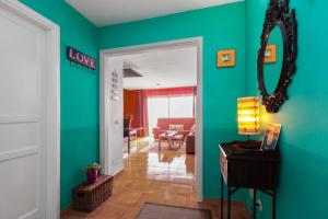 a room with a green wall and a mirror at The Colors House, 513 nice and cosy in Costa Teguise