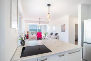 a kitchen and living room with a large counter top at Modern beautiful apartment close to the center in Bratislava