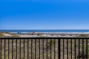 a view of the beach from a balcony at Condo w Google Mini Home in Fernandina Beach