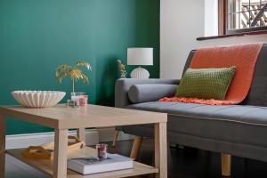 a living room with a couch and a table at 2 King 4 Singles 2 Sofa Beds Driveway Parking x 3 Private Garden Decking in Hillingdon +15 photos