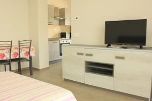 a living room with a flat screen tv on a cabinet at Villa Savi in Bergamo +11 photos