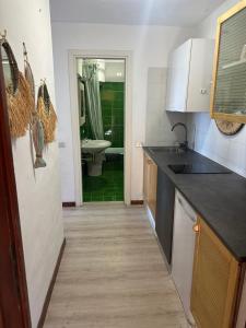 a kitchen with a sink and a bathroom with a shower at Vista Smeralda in Porto Rotondo +5 photos
