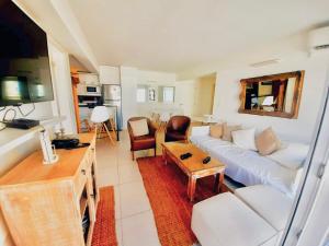 a living room with a white couch and a table at LUX TOWER Punta del Este Port in Punta del Este