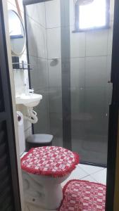 a bathroom with a shower with a toilet and a sink at Casa da iluminada in Belém