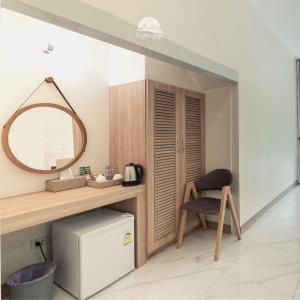 a room with a vanity with a mirror and a chair at Erachon Raft Resort in Ban Tha Thong Mon