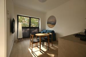 a kitchen with a table and chairs in a room at Dluga Grobla 6 Apartments Oldtown in Gdańsk