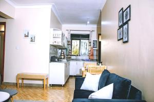a living room with a couch and a kitchen at SkyNest 2BR Modern Apt Unit in Soroti