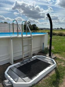 a swimming pool with a metal gate next to a pool at Mein alter Bauernhof Strassburgerhof in Welling +12 photos