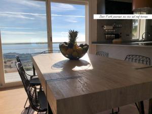 a bowl of fruit on a wooden table in a kitchen at Villa Oasis Costa Brava in Lloret de Mar