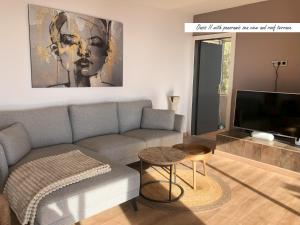a living room with a couch and a tv at Villa Oasis Costa Brava in Lloret de Mar